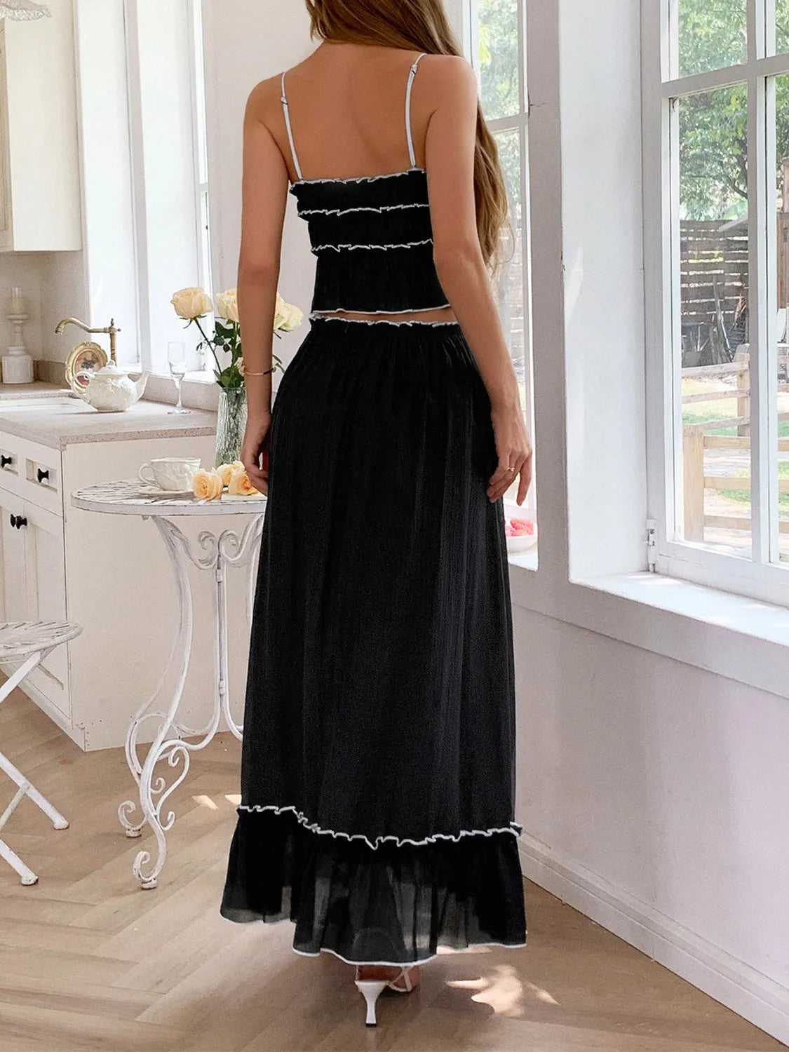 features a charming square neck cami with delicate frill detailing and matching maxi skirt.