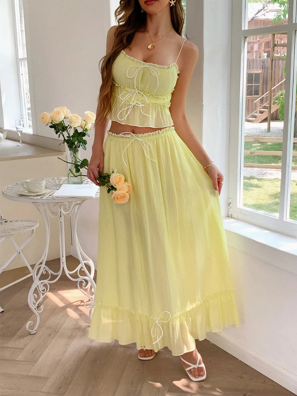 features a charming square neck cami with delicate frill detailing and matching maxi skirt.