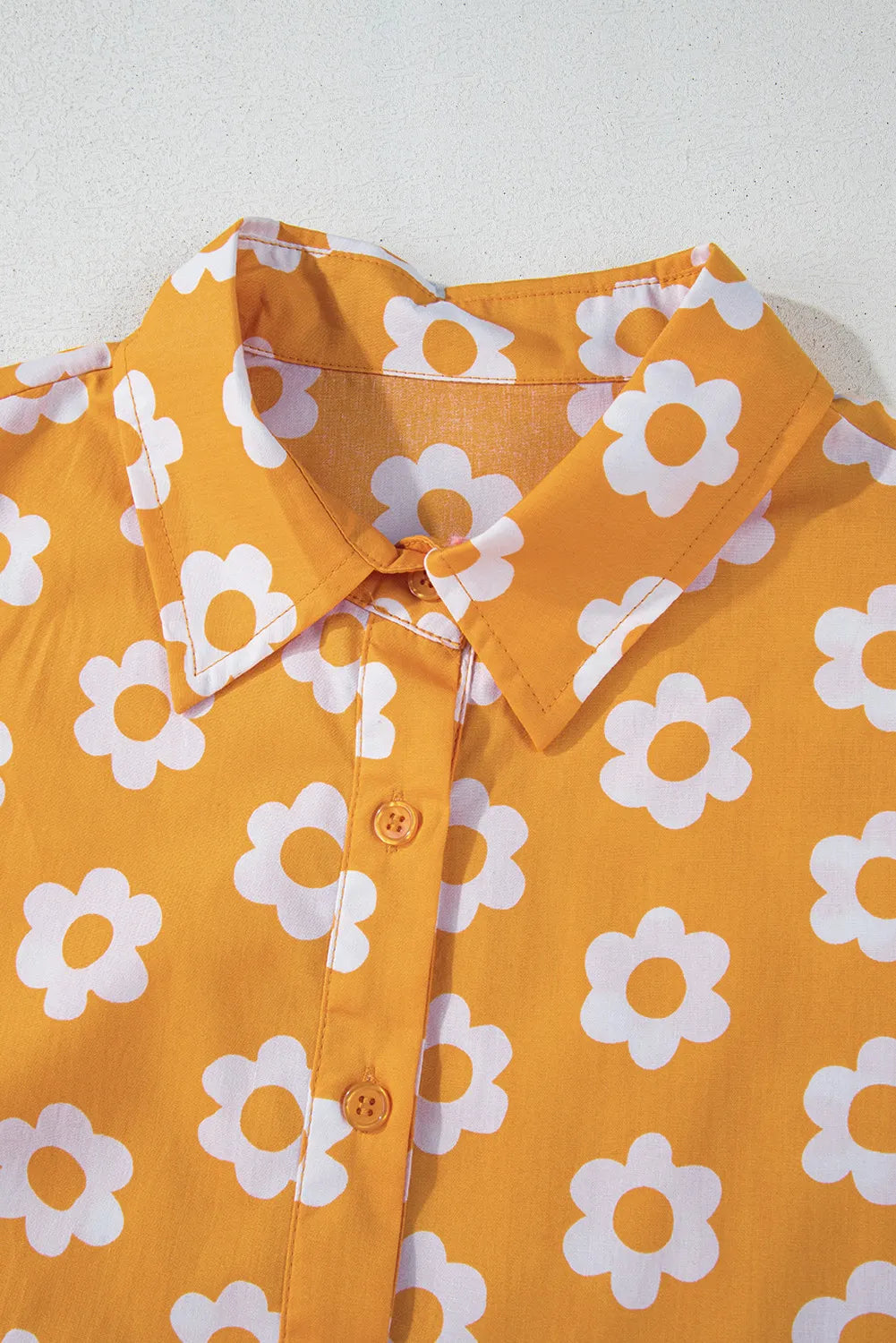 This charming yellow floral dress features a classic collar neckline and comfortable three-quarter sleeves.