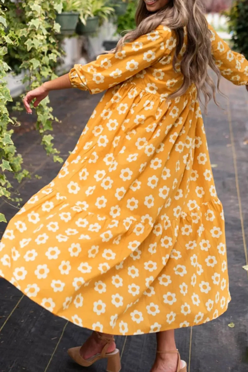 This charming yellow floral dress features a classic collar neckline and comfortable three-quarter sleeves.