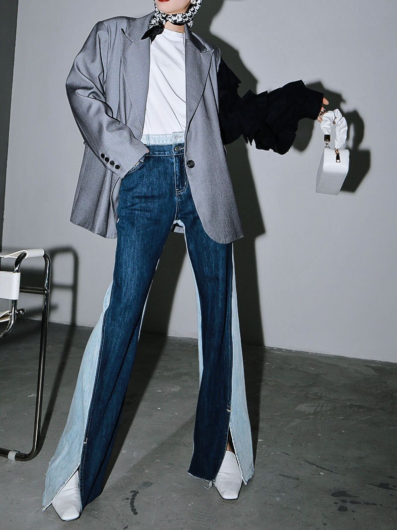 Woman wearing blue Sawako Loose Denim Wide Leg Pants with distinctive side split.