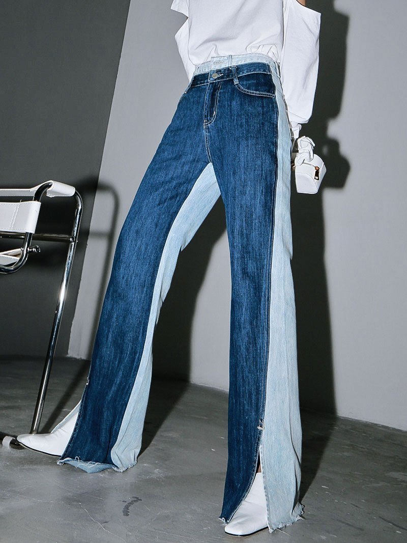 Woman wearing blue Sawako Loose Denim Wide Leg Pants with distinctive side split.