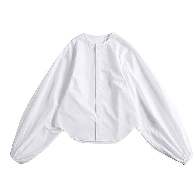 Woman wearing white Ai Enkei Loop Sleeve Shirt with dramatic balloon sleeves.