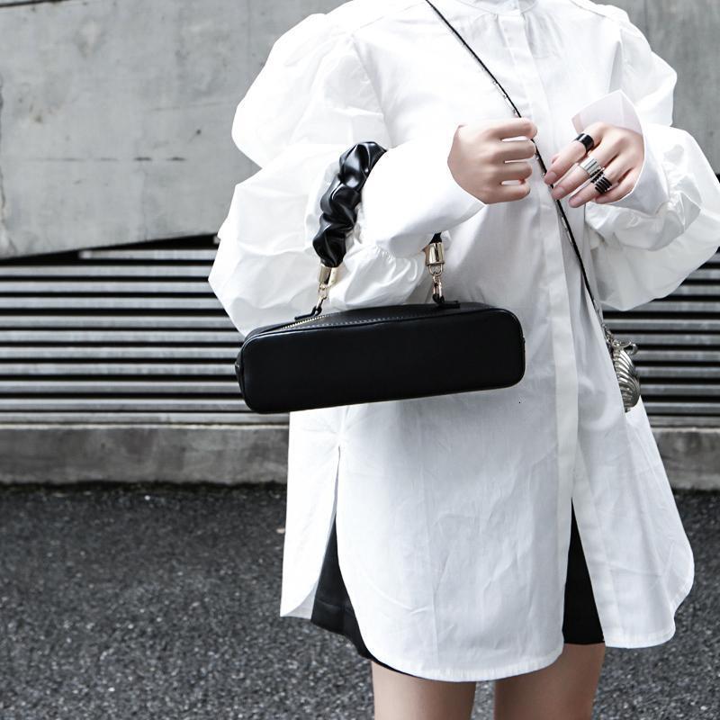 Woman wearing white Daoko Pleated Puff Long Sleeve Shirt with dramatic volume sleeves.