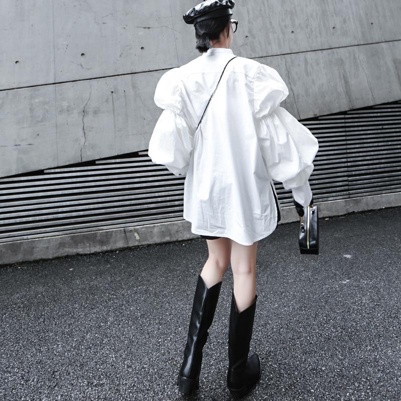 Woman wearing white Daoko Pleated Puff Long Sleeve Shirt with dramatic volume sleeves.