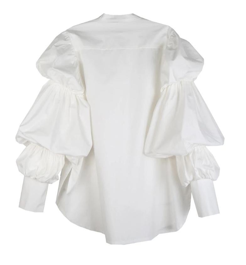 Woman wearing white Daoko Pleated Puff Long Sleeve Shirt with dramatic volume sleeves.