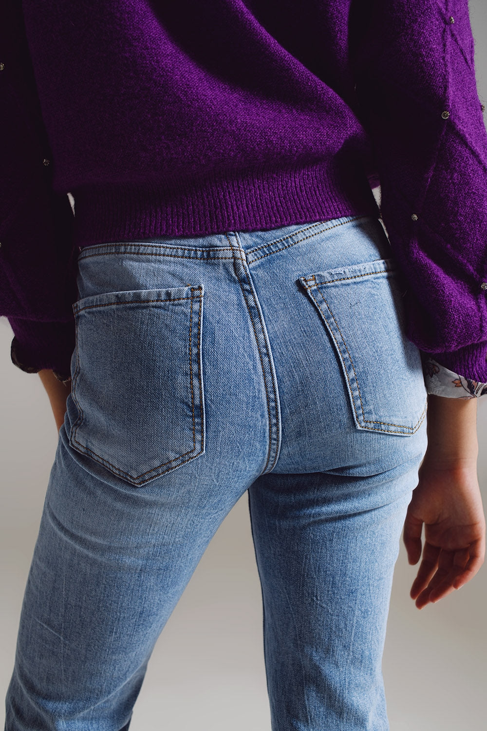Elevate your everyday style with our Straight Leg Jeans With Distressed Hem in Light Blue.
