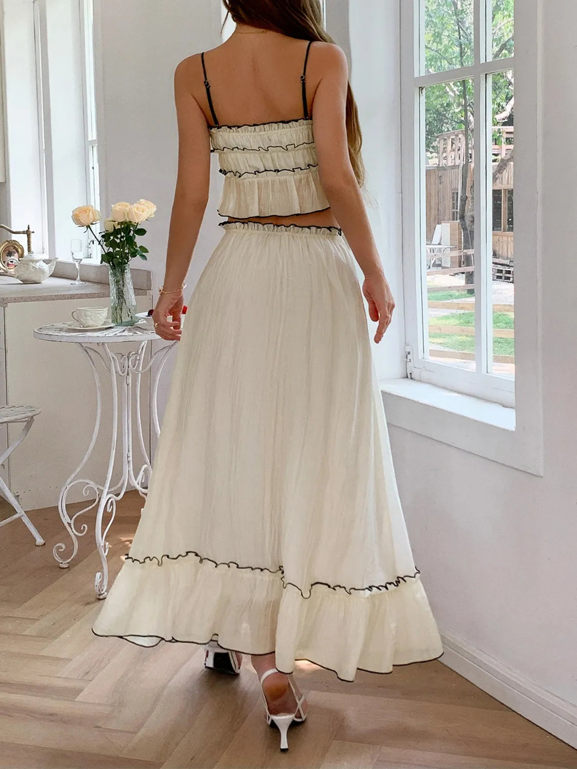 features a charming square neck cami with delicate frill detailing and matching maxi skirt.