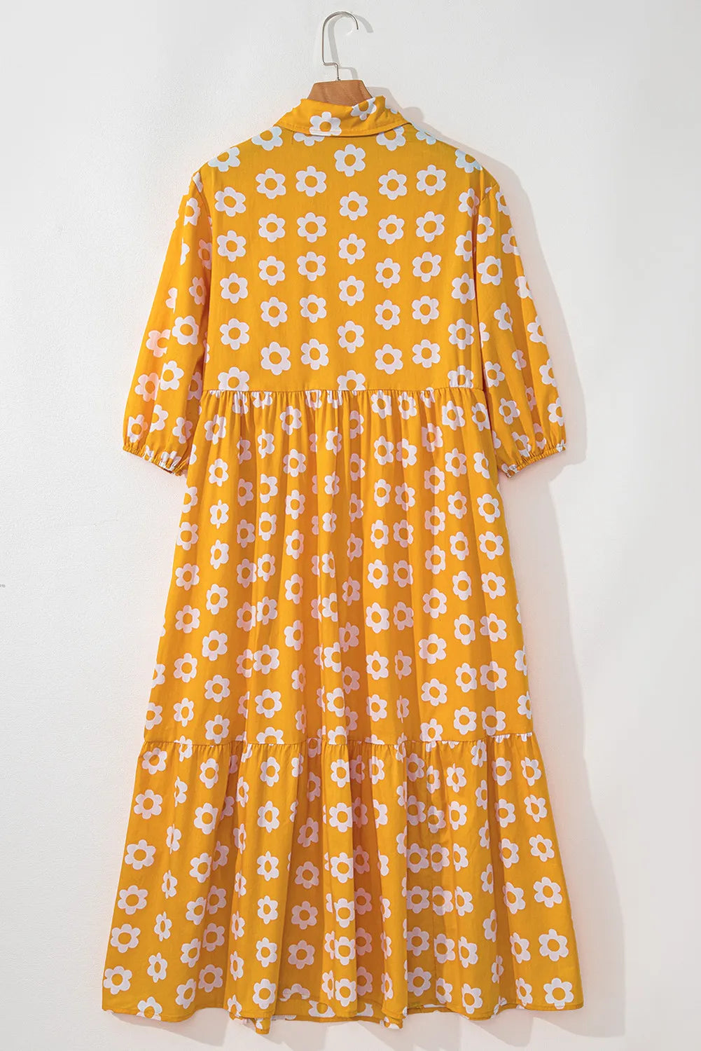 This charming yellow floral dress features a classic collar neckline and comfortable three-quarter sleeves.