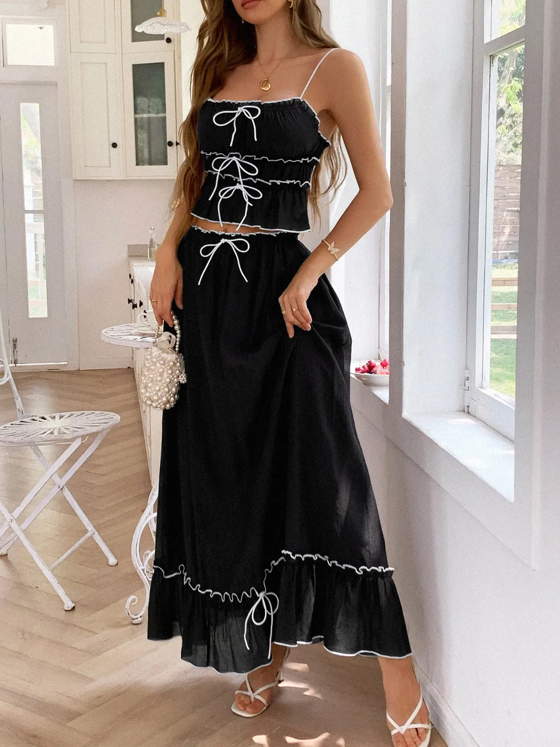 features a charming square neck cami with delicate frill detailing and matching maxi skirt.