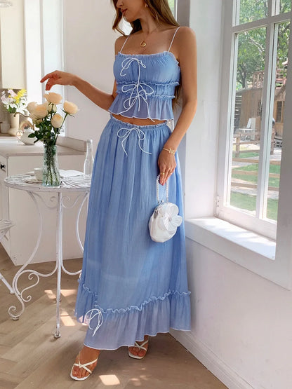 features a charming square neck cami with delicate frill detailing and matching maxi skirt.