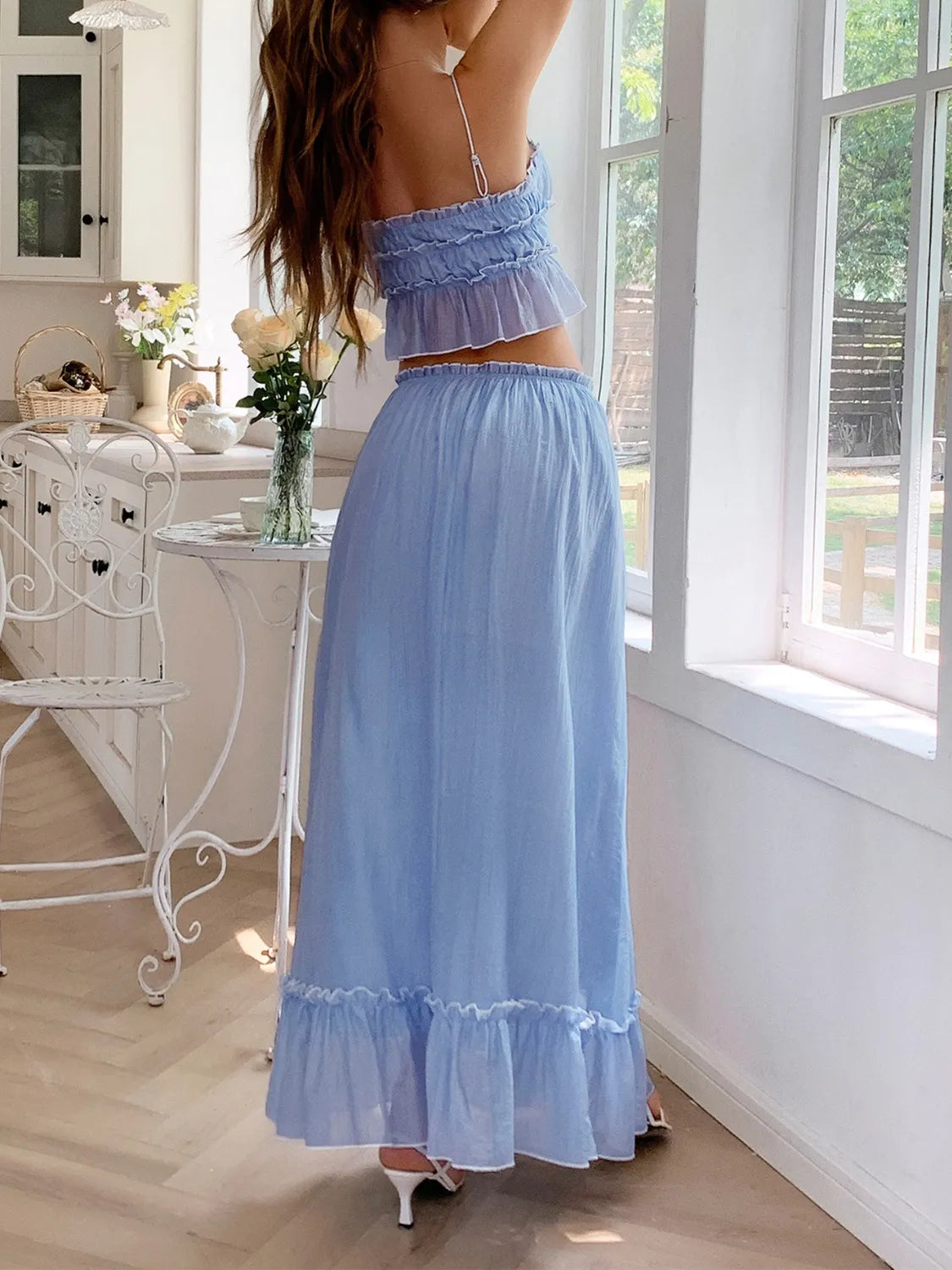 features a charming square neck cami with delicate frill detailing and matching maxi skirt.
