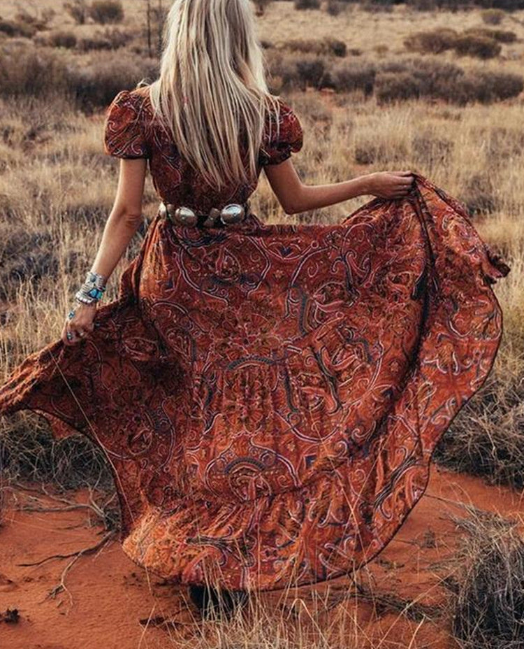 Embrace bohemian elegance with this stunning red maxi dress featuring a bold paisley print.