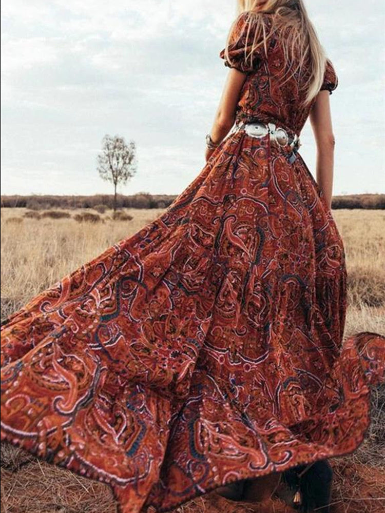 Embrace bohemian elegance with this stunning red maxi dress featuring a bold paisley print.