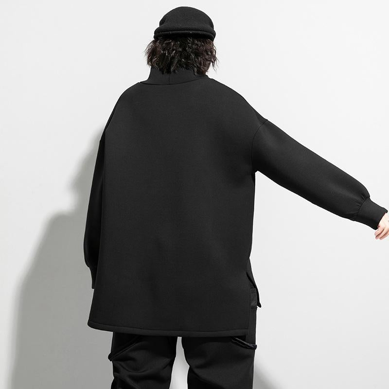 Woman wearing black oversized turtleneck pullover with utility pocket details