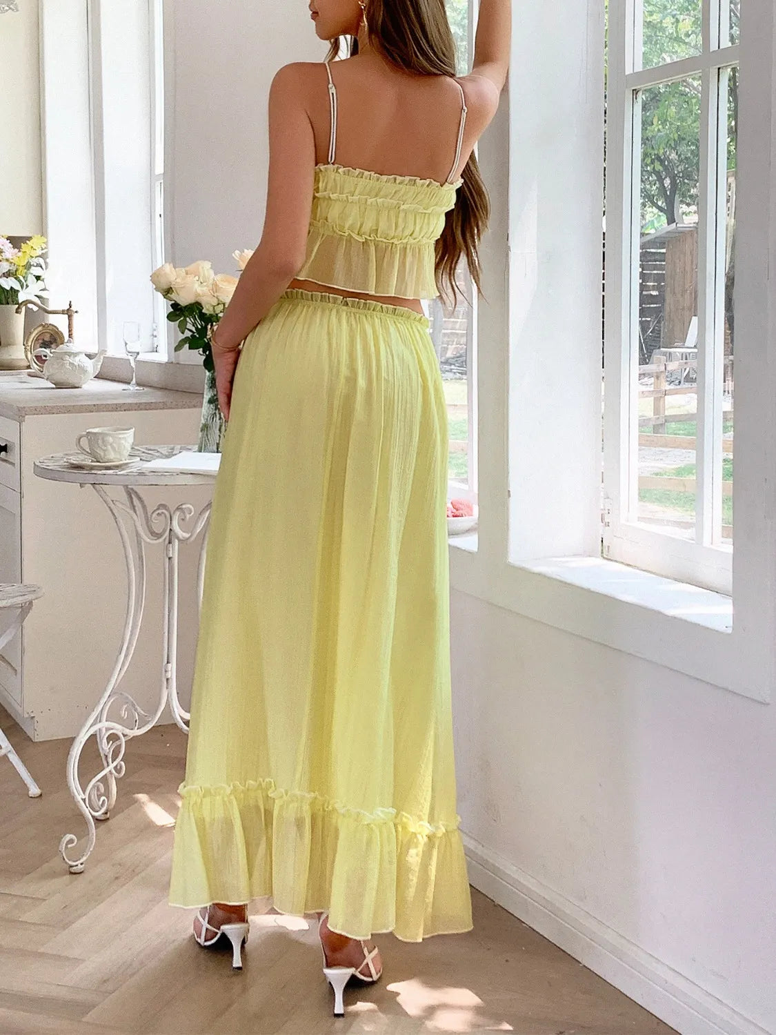 features a charming square neck cami with delicate frill detailing and matching maxi skirt.