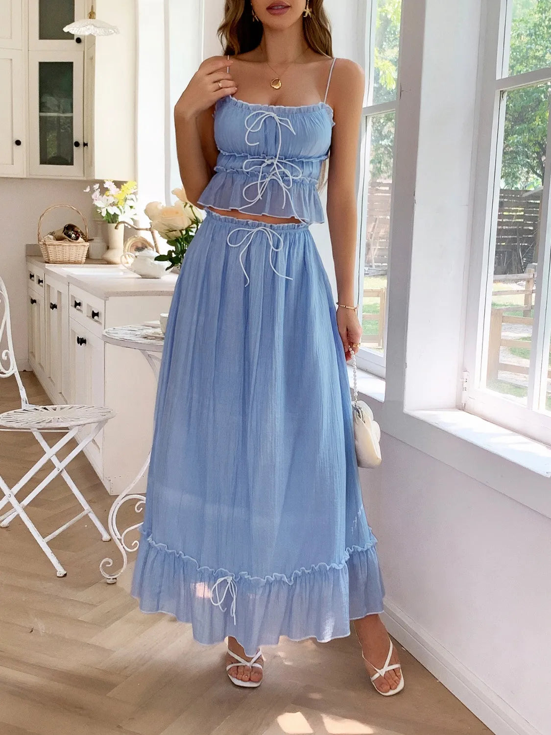 features a charming square neck cami with delicate frill detailing and matching maxi skirt.
