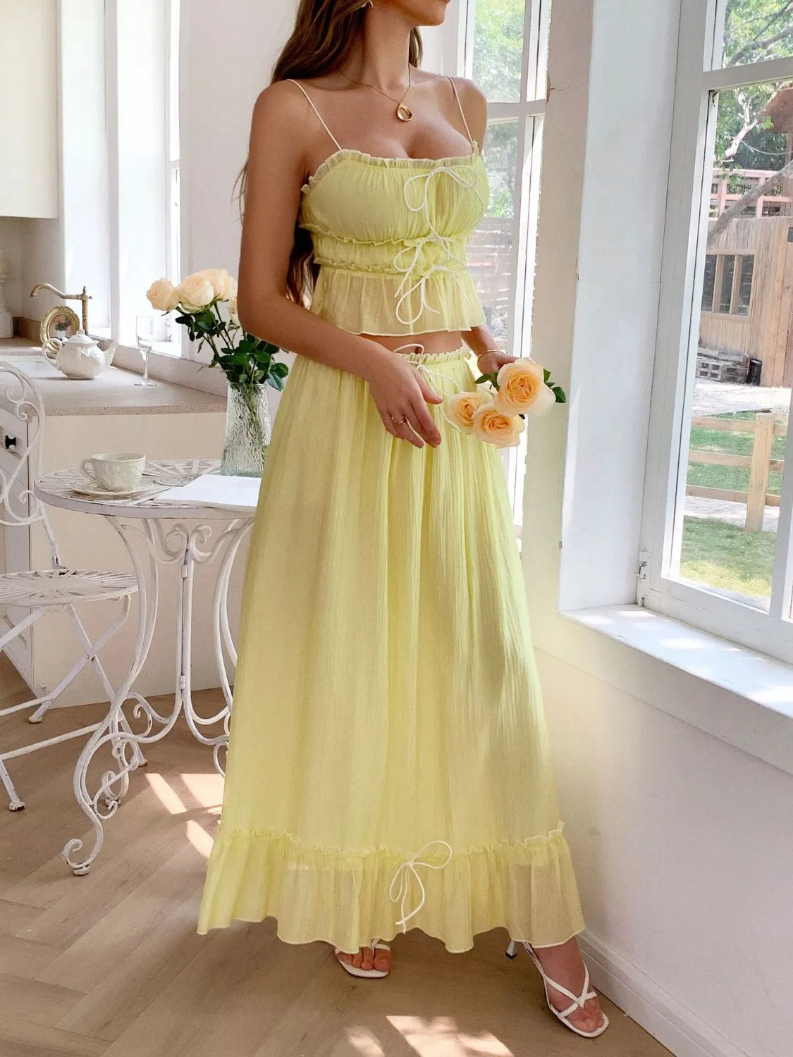 features a charming square neck cami with delicate frill detailing and matching maxi skirt.