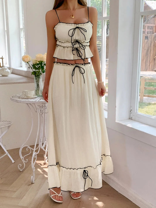 features a charming square neck cami with delicate frill detailing and matching maxi skirt.