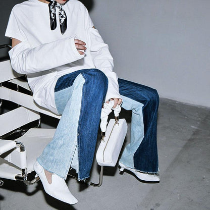 Woman wearing blue Sawako Loose Denim Wide Leg Pants with distinctive side split.