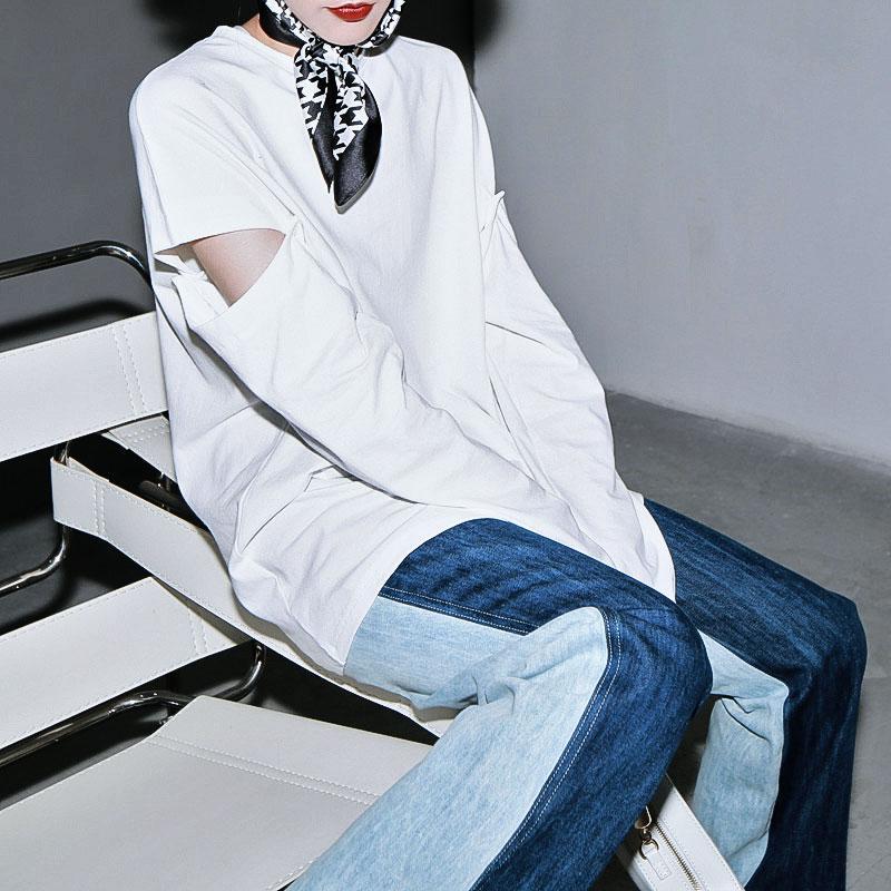 Woman wearing blue Sawako Loose Denim Wide Leg Pants with distinctive side split.