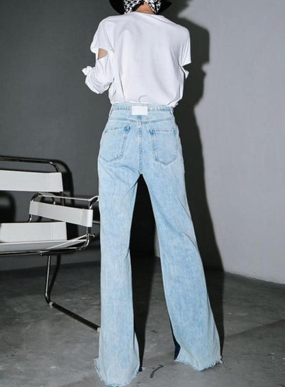 Woman wearing blue Sawako Loose Denim Wide Leg Pants with distinctive side split.