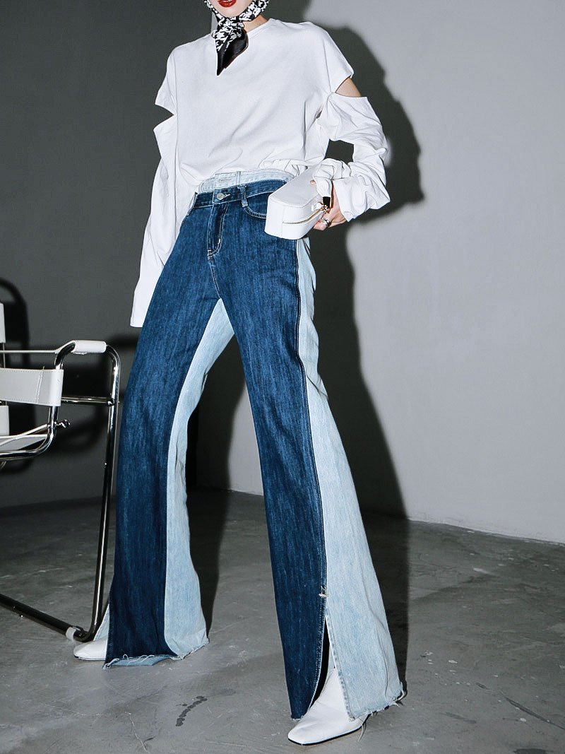 Woman wearing blue Sawako Loose Denim Wide Leg Pants with distinctive side split.