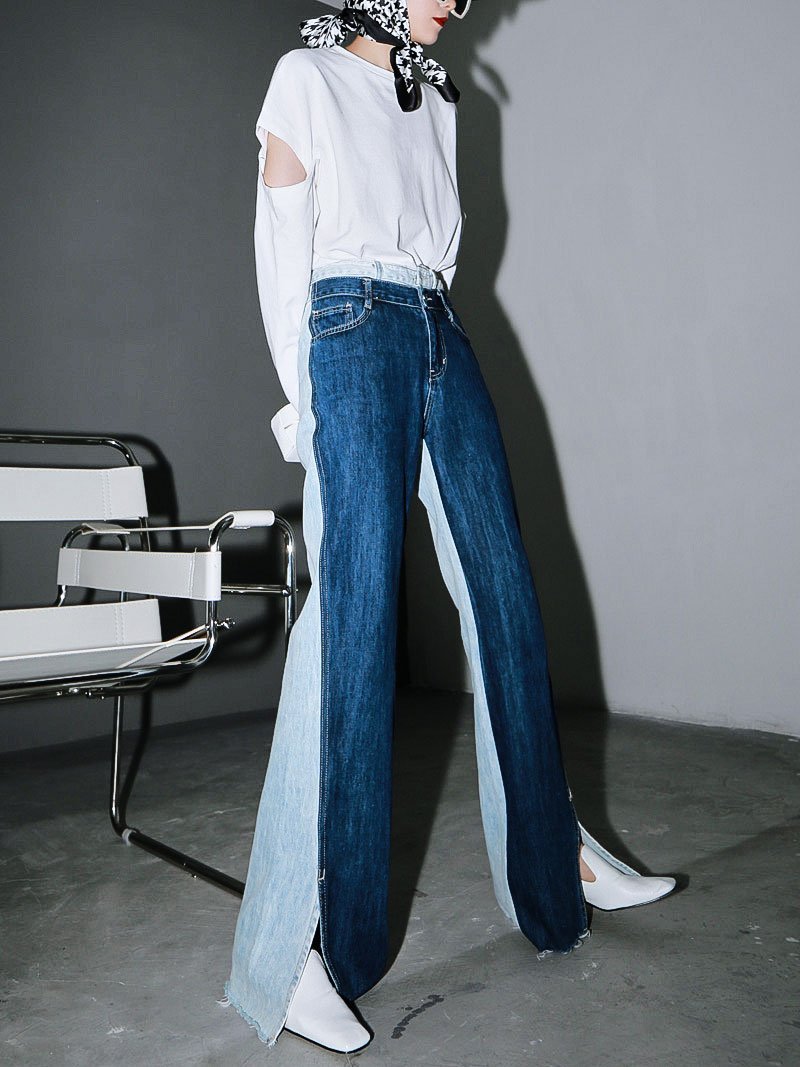Woman wearing blue Sawako Loose Denim Wide Leg Pants with distinctive side split.