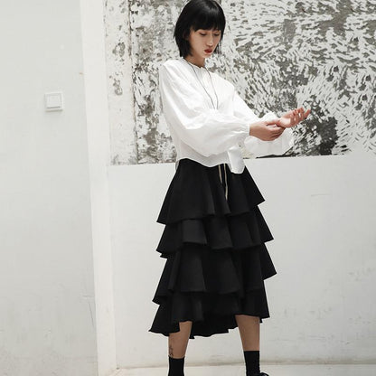 Woman wearing white Ai Enkei Loop Sleeve Shirt with dramatic balloon sleeves.