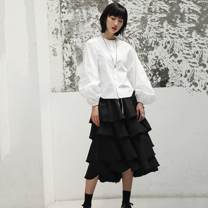 Woman wearing white Ai Enkei Loop Sleeve Shirt with dramatic balloon sleeves.