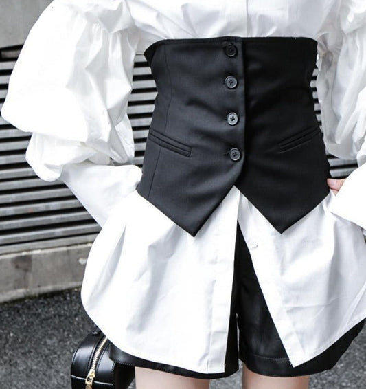 Elevate your wardrobe with our statement Akino Button Waist Vest in sophisticated black