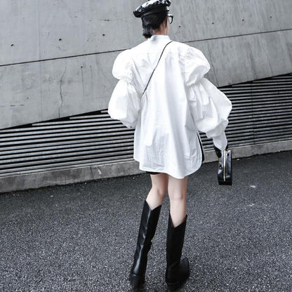 Woman wearing white Daoko Pleated Puff Long Sleeve Shirt with dramatic volume sleeves.