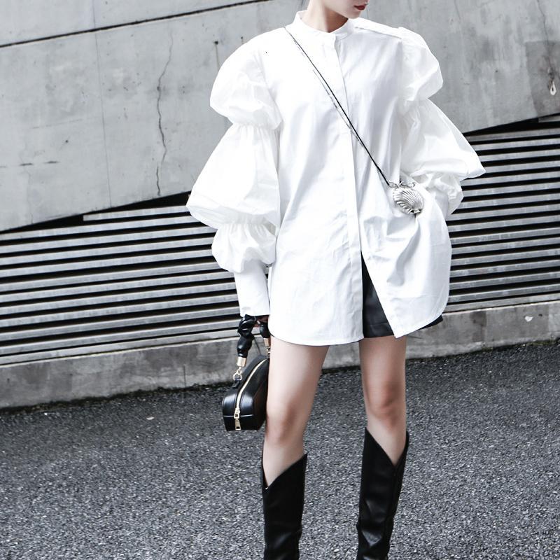 Woman wearing white Daoko Pleated Puff Long Sleeve Shirt with dramatic volume sleeves.