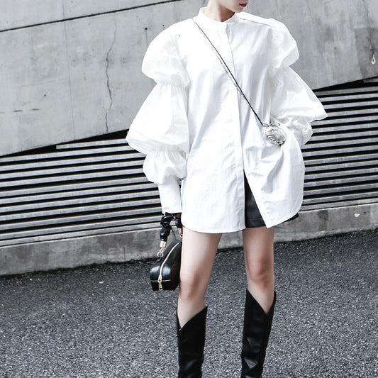 Woman wearing white Daoko Pleated Puff Long Sleeve Shirt with dramatic volume sleeves.