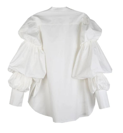 Woman wearing white Daoko Pleated Puff Long Sleeve Shirt with dramatic volume sleeves.