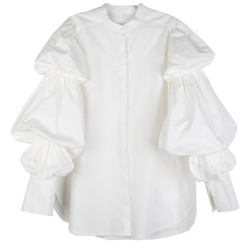Woman wearing white Daoko Pleated Puff Long Sleeve Shirt with dramatic volume sleeves.