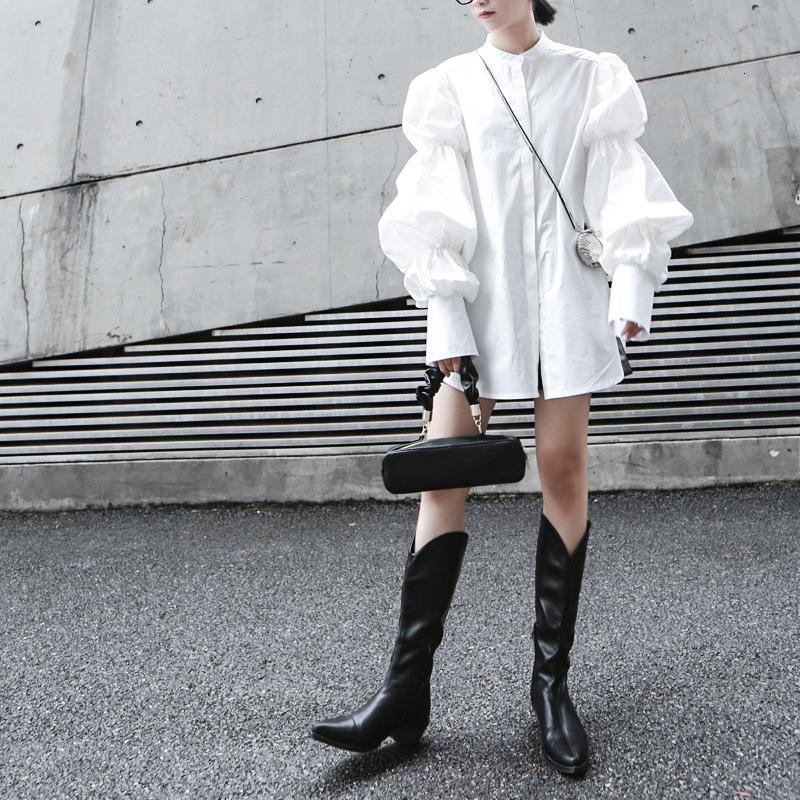 Woman wearing white Daoko Pleated Puff Long Sleeve Shirt with dramatic volume sleeves.