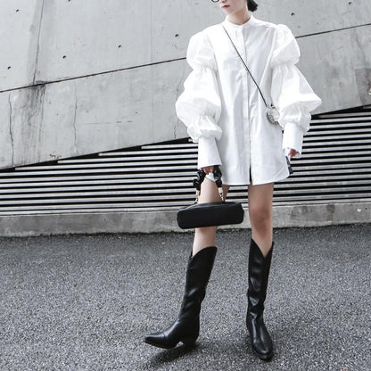 Woman wearing white Daoko Pleated Puff Long Sleeve Shirt with dramatic volume sleeves.