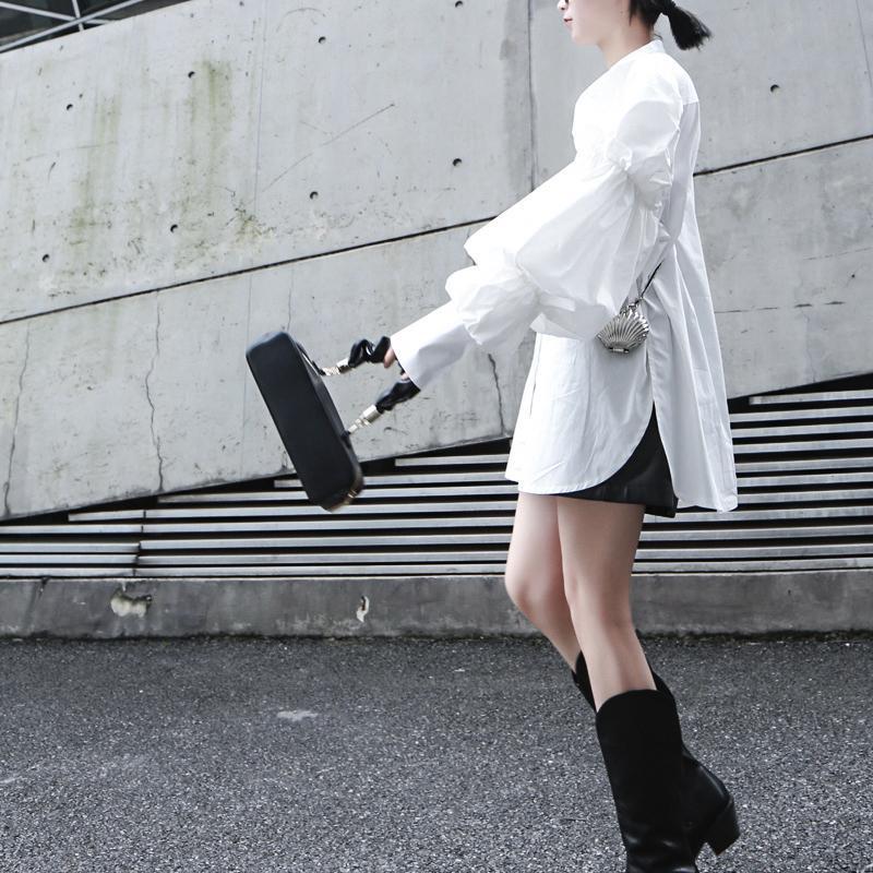 Woman wearing white Daoko Pleated Puff Long Sleeve Shirt with dramatic volume sleeves.
