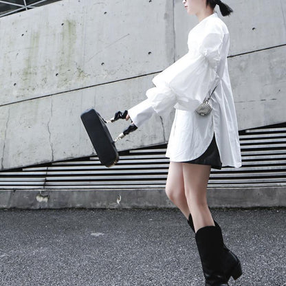 Woman wearing white Daoko Pleated Puff Long Sleeve Shirt with dramatic volume sleeves.