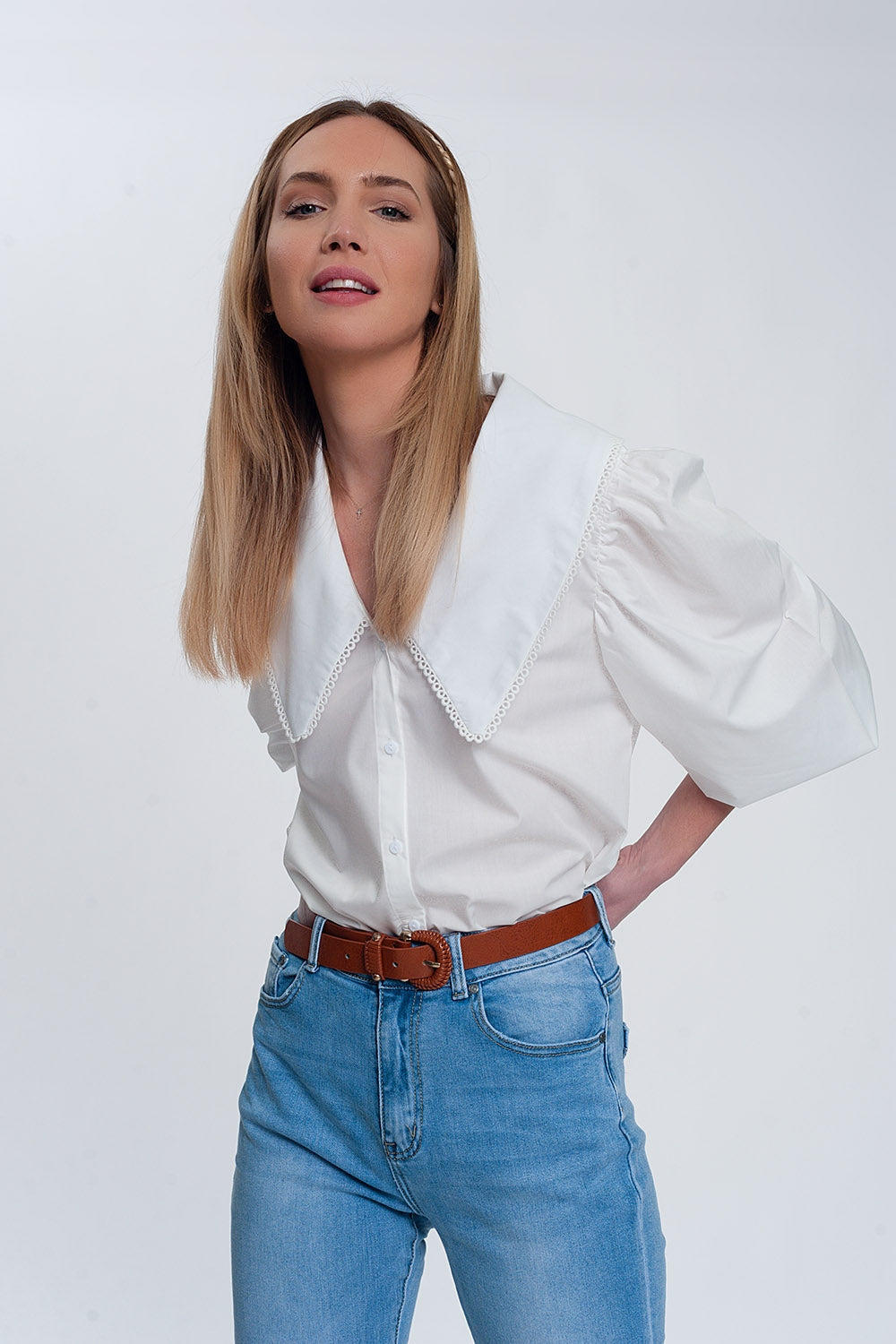 Woman wearing white oversized collared shirt with statement large collar