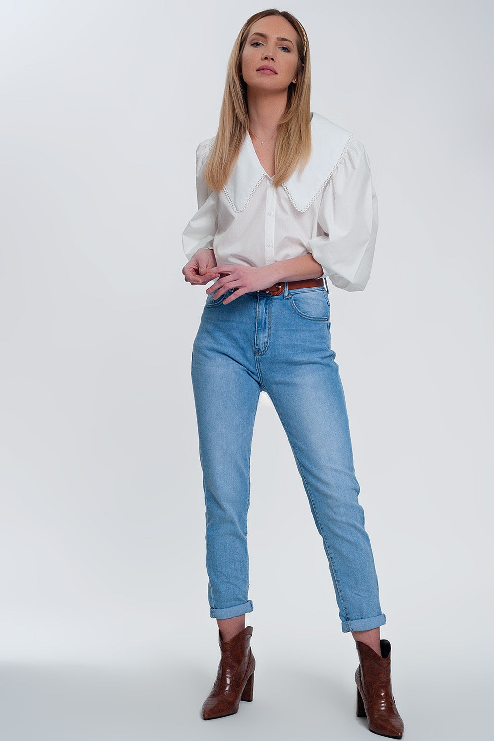 Woman wearing white oversized collared shirt with statement large collar