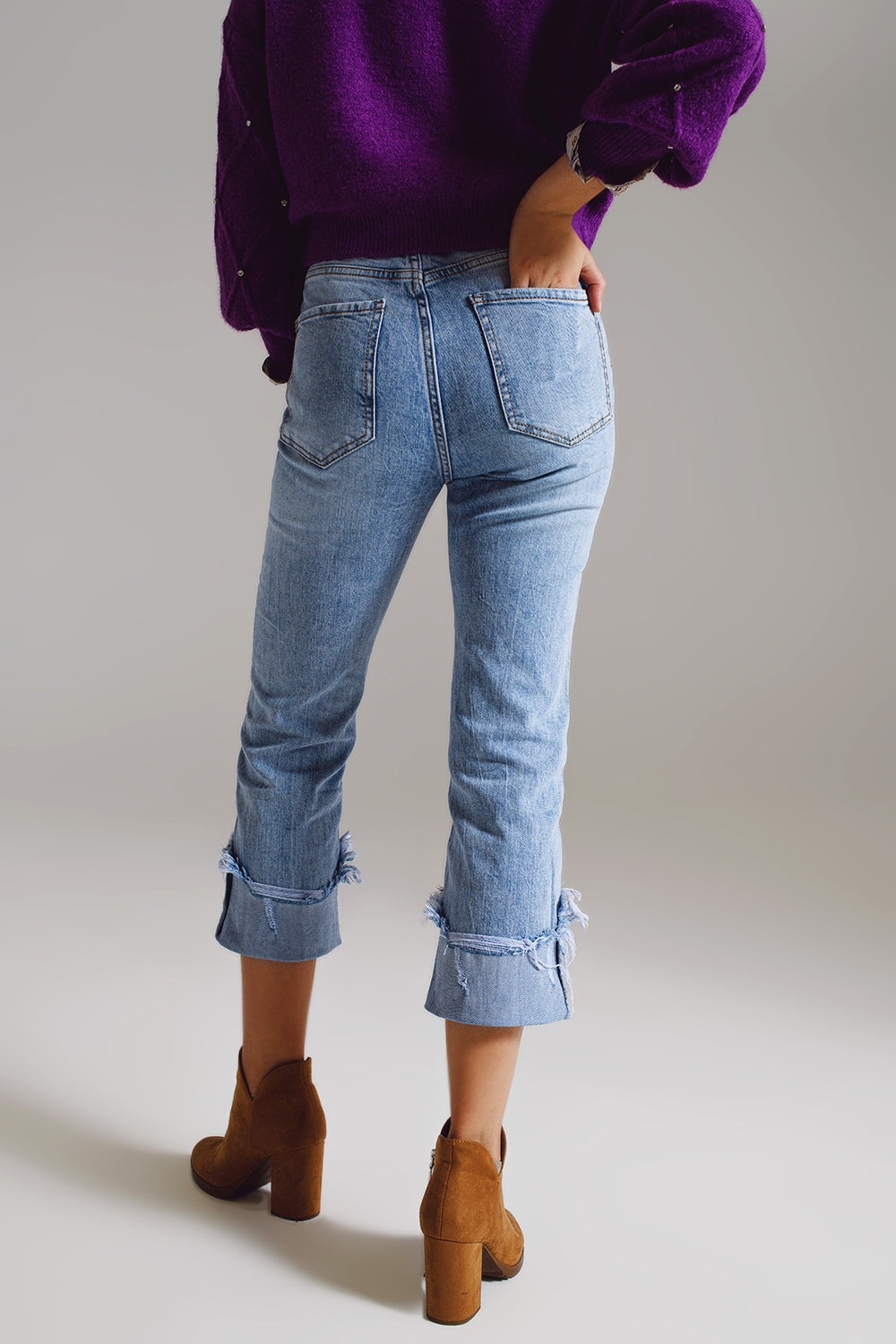 Elevate your everyday style with our Straight Leg Jeans With Distressed Hem in Light Blue.