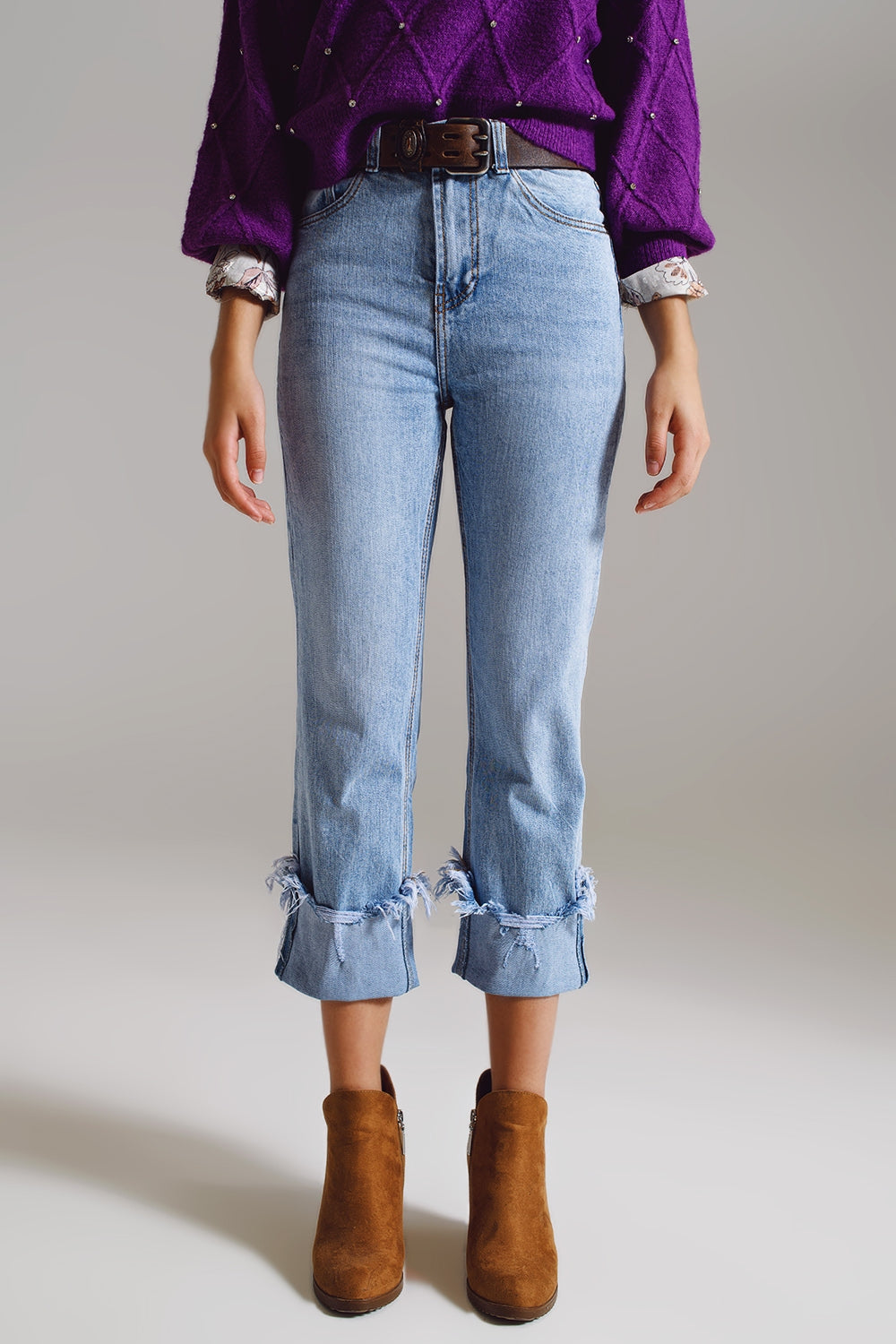 Elevate your everyday style with our Straight Leg Jeans With Distressed Hem in Light Blue.