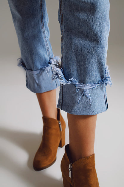 Elevate your everyday style with our Straight Leg Jeans With Distressed Hem in Light Blue.